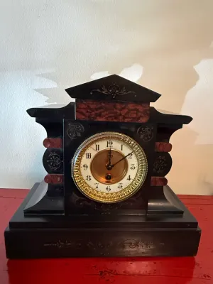 Sale Photo Thumbnail #124: Antique Victorian slate and faux-marbled mantel clock featuring engraved floral scrollwork and an ornate brass-ringed dial.