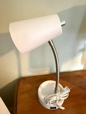 Sale Photo Thumbnail #410: Modern white gooseneck desk lamp with a flexible chrome neck and integrated base switch.