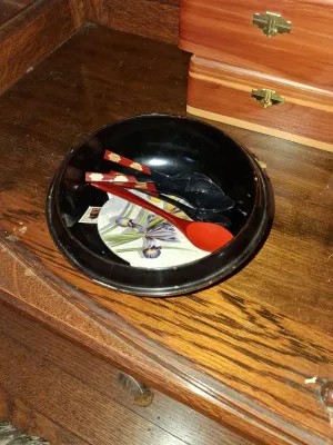 Sale Photo Thumbnail #75: Black Japanese lacquer bowl containing patterned decorative spoons, sitting on a wooden surface near two wooden keepsake boxes.