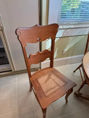 Sale Photo Thumbnail #412: Antique oak side chair featuring carved fiddleback splats, a woven cane seat insert, and cabriole front legs.