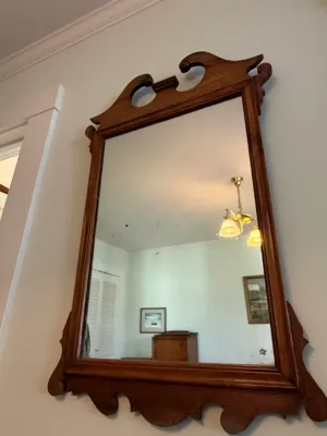 Sale Photo Thumbnail #294: Vintage Chippendale style wall mirror featuring a carved wooden frame with a swan-neck pediment crest.
