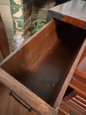 Sale Photo Thumbnail #179: Open wooden drawer showing interior construction on a Asian-style tansu cabinet with metal hardware accents.