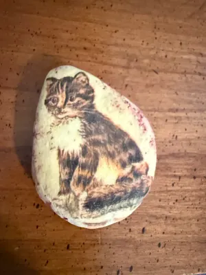 Sale Photo Thumbnail #392: Hand-painted smooth rock paperweight featuring a seated tabby cat.