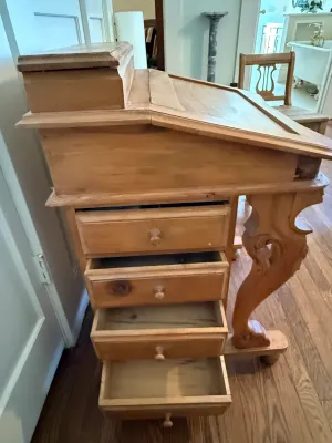 Sale Photo Thumbnail #316: Antique pine Davenport desk featuring a slanted writing surface, raised rear stationery compartment, side drawers, and carved cabriole front legs.