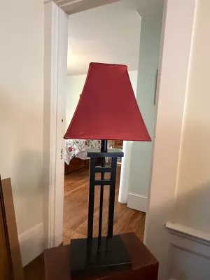 Sale Photo Thumbnail #187: Mission-style black wooden table lamp featuring a geometric lattice base design paired with a red fabric trapezoid shade.