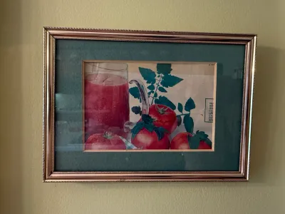 Sale Photo Thumbnail #461: Framed still life wall art featuring tomatoes and a glass mug, displayed in a metallic frame with a green mat.