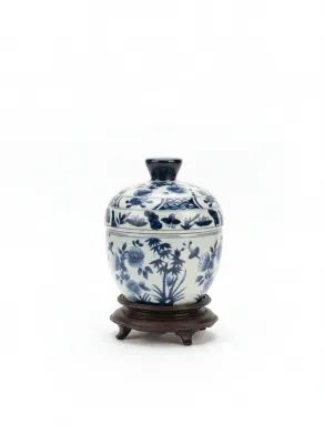 Sale Photo Thumbnail #26: Chinese blue and white hand-painted porcelain covered jar with floral and bamboo motifs, resting on a carved dark wood stand.