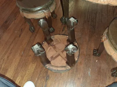 Sale Photo Thumbnail #117: Ornately carved dark wood Chinese plant stands featuring carved aprons and claw feet, with one turned upside down showing the underside cross-bracing.