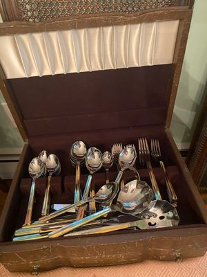 Vintage flatware set with two-tone silver and gold handles, presented in a felt-lined wooden storage chest.