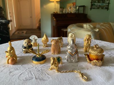 Collection of vintage enamel and jeweled trinket boxes, including various animal figurines like an owl, panda, elephant, and kitten.