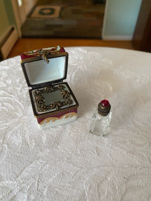 French Limoges-style porcelain hinged trinket box featuring a fitted interior with an ornate metal insert and miniature glass perfume...
