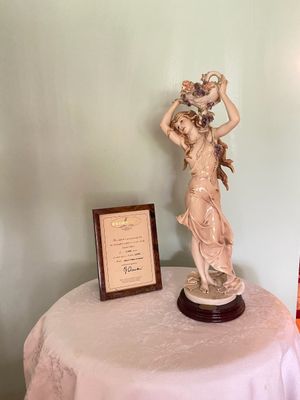 Giuseppe Armani limited edition Capodimonte porcelain figurine of a woman holding a floral vessel, accompanied by its framed certificate...