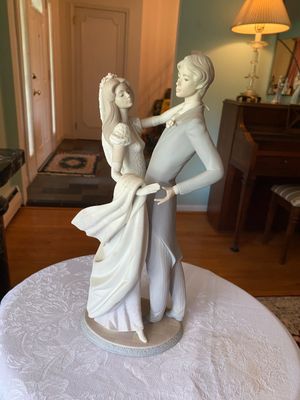 Large Lladro-style porcelain figurine depicting a bride and groom dancing, in a soft pastel matte finish.