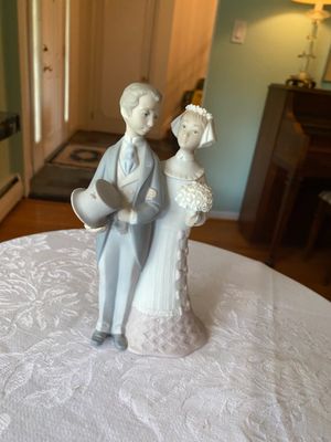 Vintage Lladro style porcelain bride and groom figurine in muted pastel tones.