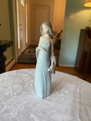 Lladró porcelain figurine of an elegant young woman in a soft blue strapless gown holding a shawl.