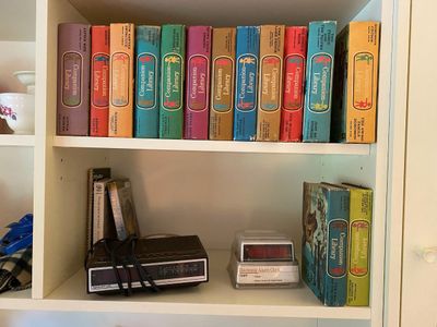Collection of vintage Grosset & Dunlap Companion Library hardback children's books displayed on a bookshelf alongside two...