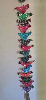 Sale Photo Thumbnail #35: Handcrafted Indian toran wall hanging featuring a vertical strand of colorful stuffed fabric birds with sequin embellishments and a metal bell at the bottom.