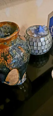 Sale Photo Thumbnail #18: Handcrafted studio pottery vase with a multicolor drip glaze alongside a mirrored mosaic candle holder.