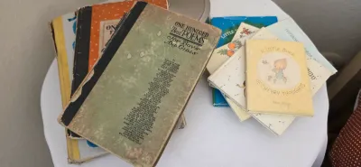 Sale Photo Thumbnail #48: Collection of vintage children's books and poetry booklets, including 'One Hundred Best Poems for Boys and Girls' and 'A Little Book of Cheery Thoughts', showing heavy wear and age.