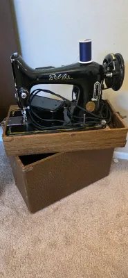Sale Photo Thumbnail #68: Vintage BelAir Bantam black electric sewing machine with foot pedal, power cord, and original textured carrying case.