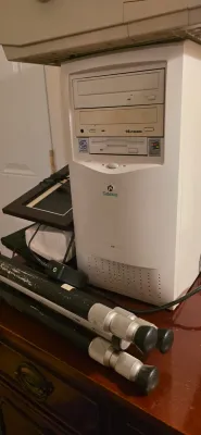 Sale Photo Thumbnail #21: Vintage Gateway mid-tower PC case with optical drives and floppy drive, circa late 1990s to early 2000s, displayed alongside a black tripod.