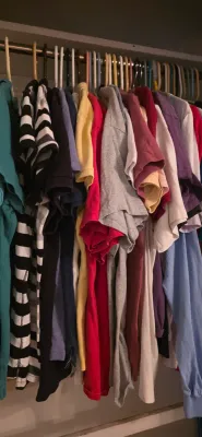 Sale Photo Thumbnail #42: Closet filled with various men's and women's t-shirts and casual shirts on plastic hangers.