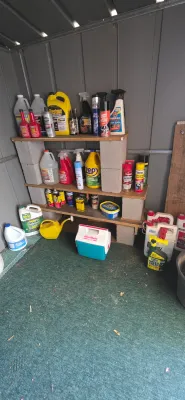 Sale Photo Thumbnail #56: Storage shed shelf unit organized with various automotive fluids, household cleaners, lawn chemicals, and a vintage Igloo MiniMate cooler.