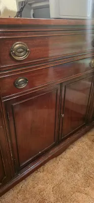 Sale Photo Thumbnail #17: Traditional mahogany sideboard featuring brass oval drop-handle pulls and lower cabinet doors.