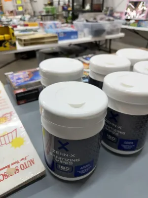Sale Photo Thumbnail #10: Multiple tubs of Zehn-X sanitizing wipes, each containing 180 wipes, set out for sale.