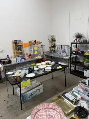 Sale Photo Thumbnail #5: An assortment of household goods including glassware, mugs, ceramic plates, kitchen appliances, media, and home decor items.