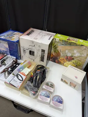 Sale Photo Thumbnail #26: Assortment of boxed home goods and cookware, including Belgique chafing dishes, glass serving dishes, coaster sets, and electronic cables.