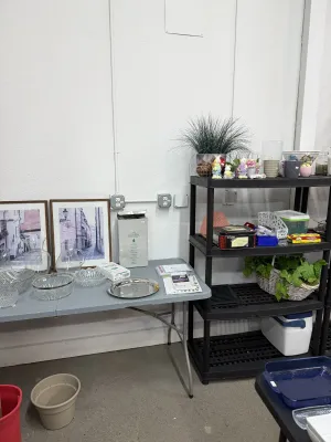 Sale Photo Thumbnail #23: Collection of home decor items including framed architectural prints, cut glass serving bowls, glass pitchers, and decorative shelving displays.