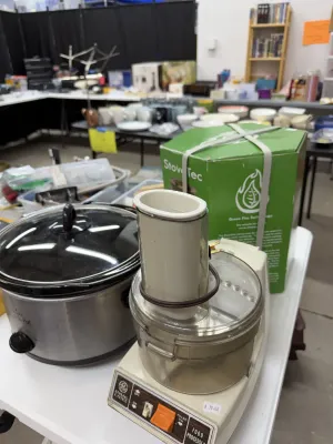 Sale Photo Thumbnail #7: Vintage General Electric food processor with a clear plastic bowl, sitting alongside a stainless steel Crock-Pot slow cooker and a boxed StoveTec stove.