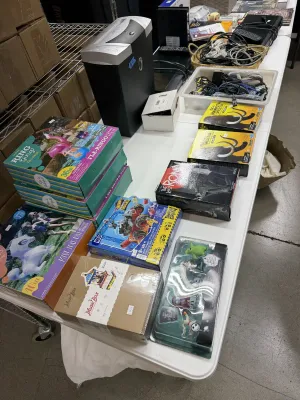 Sale Photo Thumbnail #32: Collection of boxed toys, games, model kits, and small household electronics, including an office paper shredder, inflatable pool toys, and collectible action figures.