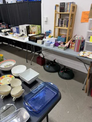 Sale Photo Thumbnail #20: Selection of household items, including ceramic serving bowls, tea cups, Pyrex glassware, DVDs, small appliances, and two Christmas tree stands.