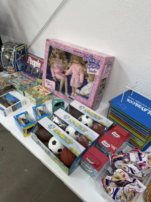Sale Photo Thumbnail #19: Collection of vintage and modern toys and games, including boxed Always Sisters dolls, GoPlay Pro-Ball sets, board games, and a Playskool storage rack.