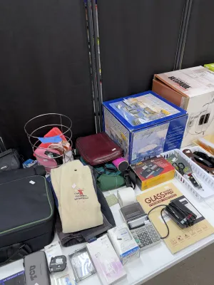 Sale Photo Thumbnail #30: Selection of assorted household and electronic items, including boxed chafing dishes, travel bags, Golf Goddess Invitational apparel, small electronics, and office accessories.