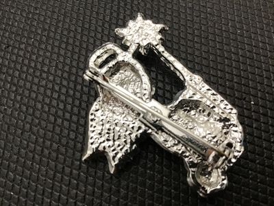 Sale Photo Thumbnail #118: A vintage silver-tone metal brooch depicting a flying angel or fairy in a light blue dress with textured wings, blonde hair, and holding a wand topped with a star and a red rhinestone accent. Features colorful enamel painted details. Pin back clasp mechan
