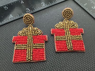 Sale Photo Thumbnail #175: Pair of festive Christmas present-shaped drop post earrings. Features red and gold seed bead embellishments on the front with a soft red felt backing. Measures approximately 2.5 inches in length. Good pre-owned condition with no visible missing beads or d
