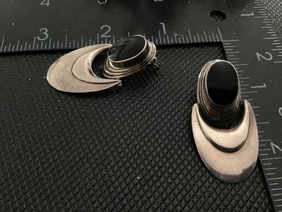 Sale Photo Thumbnail #85: Pair of modern statement dangle post earrings featuring black onyx cabs mounted in sterling silver. Stamped 'NF 925' on the reverse. Modernist/contemporary design with crescent shaped dangling drops. Measure approximately 2 inches long. Show light vintage
