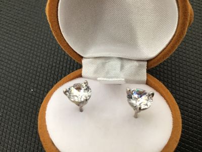 Sale Photo Thumbnail #28: Pair of round clear solitaire stud earrings set in silver-tone prongs, presented inside a novelty flock-coated brown reindeer ornament jewelry box with a red nose and bow tie. The reindeer box measures approximately 3.5 inches long. Earrings and box are i