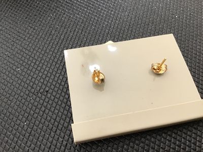 Sale Photo Thumbnail #161: Pair of vintage genuine cloisonné pierced post earrings featuring an elegant leaf shape with white enamel background, gold-tone accents, and colorful red, blue, and green rose floral motifs. Mounted on original display card marked 'GENUINE CLOISONNE'. In