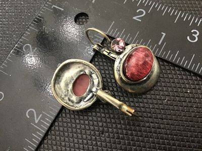 Sale Photo Thumbnail #146: Pair of vintage-style dangle earrings featuring antiqued silver-tone metal settings. Each earring has a small faceted light pink rhinestone accents above an oval bezel-set textured red/pink cabochon stone. Designed with leverback ear wires. Measure approx