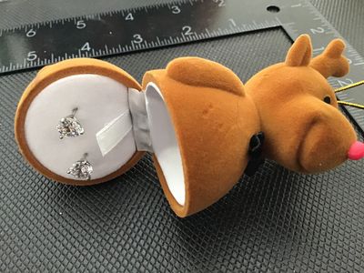 Sale Photo Thumbnail #27: Pair of round clear solitaire stud earrings set in silver-tone prongs, presented inside a novelty flock-coated brown reindeer ornament jewelry box with a red nose and bow tie. The reindeer box measures approximately 3.5 inches long. Earrings and box are i
