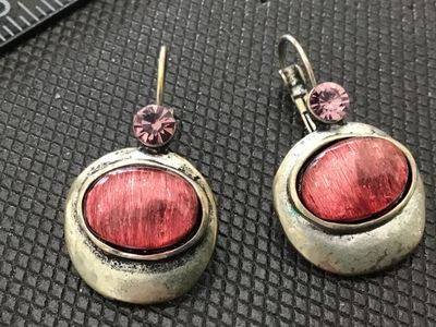 Sale Photo Thumbnail #145: Pair of vintage-style dangle earrings featuring antiqued silver-tone metal settings. Each earring has a small faceted light pink rhinestone accents above an oval bezel-set textured red/pink cabochon stone. Designed with leverback ear wires. Measure approx