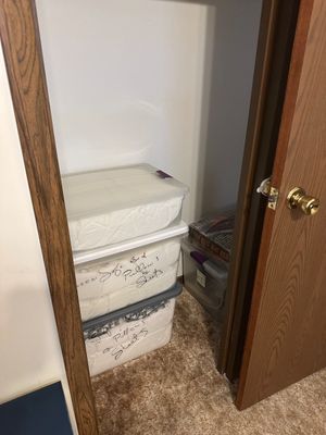 Sale Photo Thumbnail #8: Stack of clear plastic storage totes filled with queen sofa bed pillows and sheets, stored inside a closet.