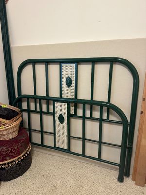 Sale Photo Thumbnail #11: Vintage dark green metal headboard and footboard set featuring woven cane center accents and raised decorative medallions.