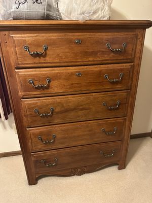 Sale Photo Thumbnail #10: Traditional five-drawer wood chest of drawers featuring ornate antique-style brass swing bail handles and carved shell detailing at the base.