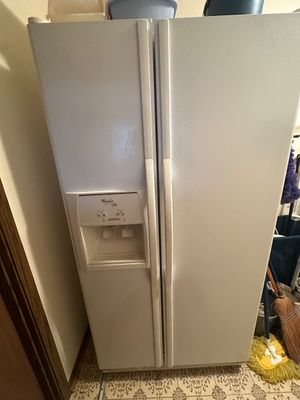 Sale Photo Thumbnail #31: Whirlpool gold  side-by-side refrigerator in white finish, featuring an in-door water and ice dispenser.