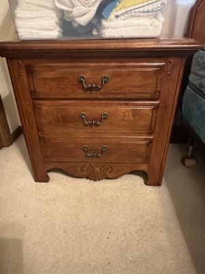 Sale Photo Thumbnail #5: Traditional wooden three-drawer nightstand featuring antiqued metal bail handles and a carved apron detail.